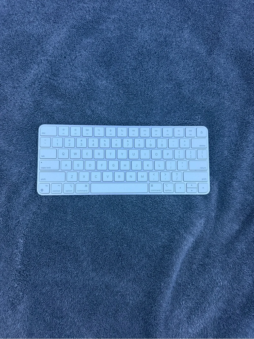 Apple Compact Magic Keyboard in White and Silver lighting cord